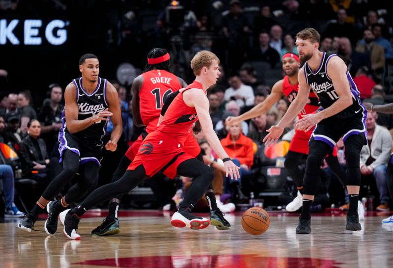 TORONTO, ON - MARCH 20: Gradey Dick #1 of the Toronto Raptors drives against Domantas Sabonis #10 of the Sacramento Kings during the first half at the Scotiabank Arena on March 20, 2024 in Toronto, Ontario, Canada. NOTE TO USER: User expressly acknowledges and agrees that, by downloading and/or using this Photograph, user is consenting to the terms and conditions of the Getty Images License Agreement. (Photo by Mark Blinch/Getty Images)