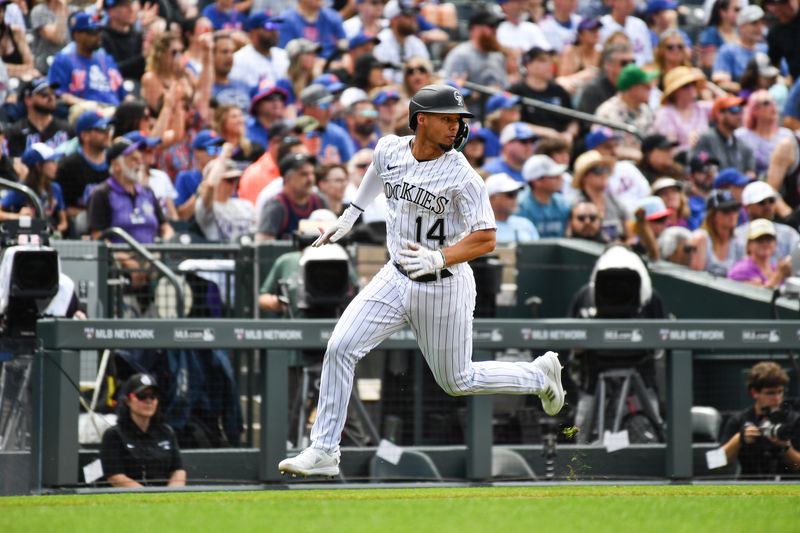 May 28, 2023; Denver, Colorado, USA; Colorado Rockies shortstop Ezequiel Tovar (14) looks back for the ball as he scores in the fifth inning against the New York Mets at Coors Field. Mandatory Credit: John Leyba-USA TODAY Sports