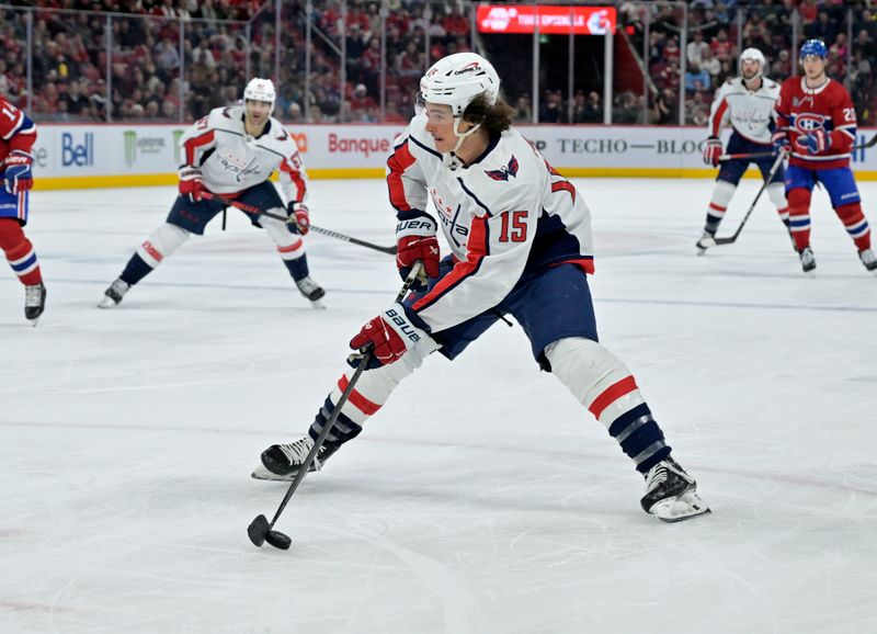 Feb 17, 2024; Montreal, Quebec, CAN; Washington Capitals forward Sonny Milano (15) plays the puck against the Montreal Canadiens during the third period at the Bell Centre. Mandatory Credit: Eric Bolte-USA TODAY Sports