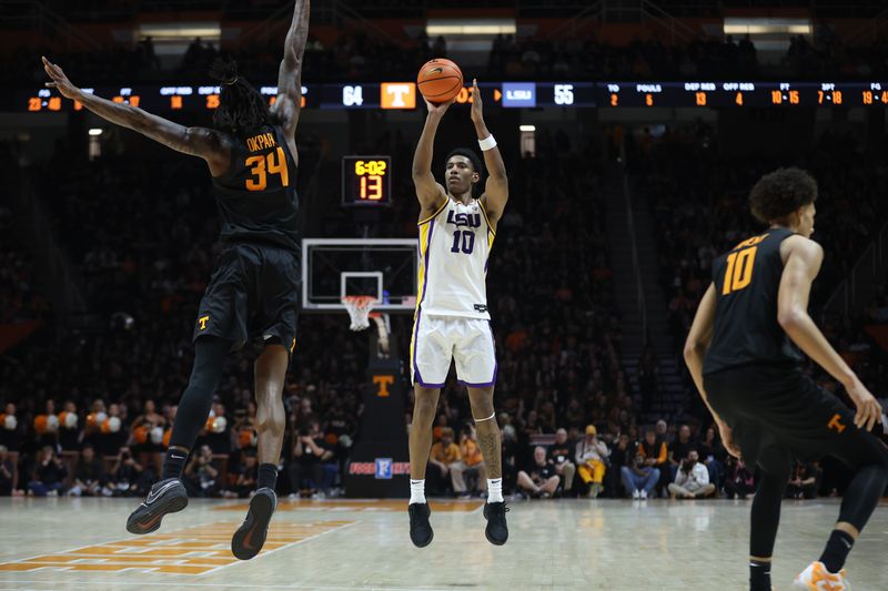 Feb 14, 2026; Knoxville, Tennessee, USA;  Louisiana State Tigers forward Marquel Sutton (10) shoots a three-point shot against Tennessee Volunteers center Felix Okpara (34) during the second half at Thompson-Boling Arena at Food City Center. Mandatory Credit: Randy Sartin-Imagn Images