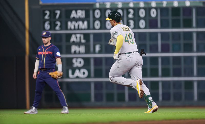 Sep 11, 2023; Houston, Texas, USA; Houston Astros third baseman Alex Bregman (2) looks on as Oakland Athletics first baseman Ryan Noda (49) rounds the bases after hitting a home run during the ninth inning at Minute Maid Park. Mandatory Credit: Troy Taormina-USA TODAY Sports