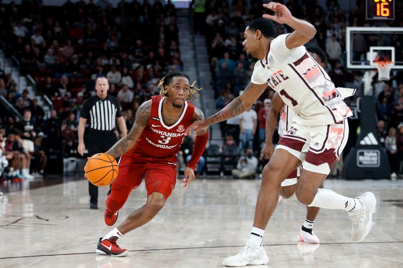 Feb 17, 2024; Starkville, Mississippi, USA; Arkansas Razorbacks guard El Ellis (3) drives to the basket against Mississippi State Bulldogs forward Tolu Smith (1) during the second half at Humphrey Coliseum. Mandatory Credit: Petre Thomas-USA TODAY Sports