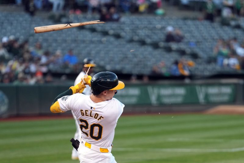 Aug 23, 2024; Oakland, California, USA; Oakland Athletics second baseman Zack Gelof (20) breaks his bat during a swing against the Milwaukee Brewers in the first inning at Oakland-Alameda County Coliseum. Mandatory Credit: Darren Yamashita-USA TODAY Sports