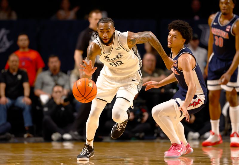 Jan 17, 2026; Orlando, Florida, USA;  Central Florida Knights forward Jordan Burks (99) steals the ball in the first half against the Arizona Wildcats at Addition Financial Arena. Mandatory Credit: Russell Lansford-Imagn Images