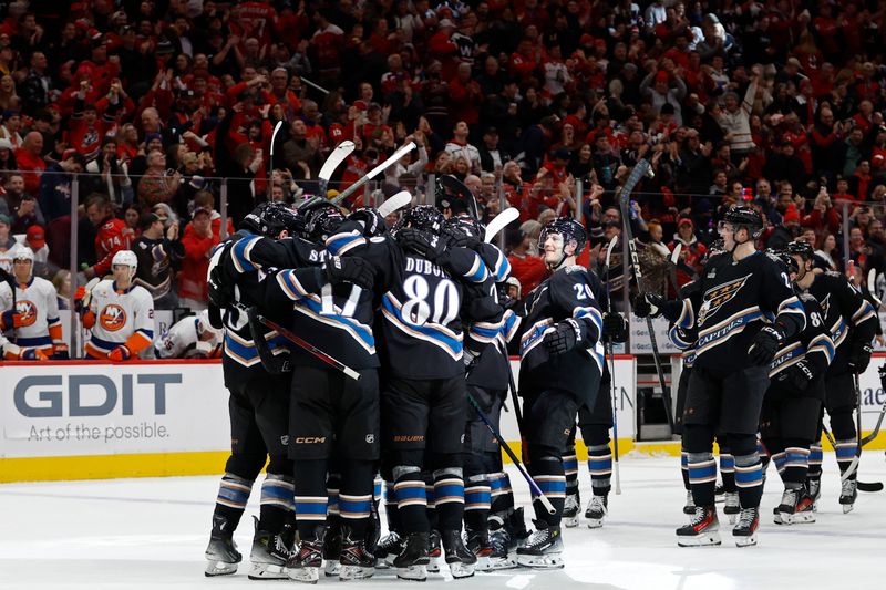 Nov 29, 2024; Washington, District of Columbia, USA; Washington Capitals players celebrate after their game against the New York Islanders at Capital One Arena. Mandatory Credit: Geoff Burke-Imagn Images