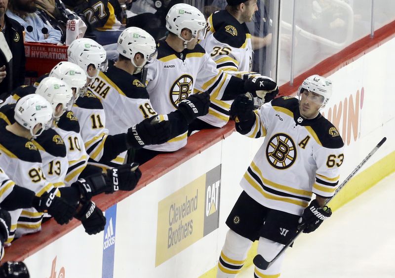 Nov 1, 2022; Pittsburgh, Pennsylvania, USA;  Boston Bruins left wing Brad Marchand (63) celebrates his power play goal with the Bruins bench against the Pittsburgh Penguins during the second period at PPG Paints Arena. Mandatory Credit: Charles LeClaire-USA TODAY Sports