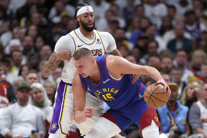 DENVER, COLORADO - APRIL 20: Nikola Jokic #15 of the Denver Nuggets drives against Anthony Davis #3 of the Los Angeles Lakers in the first quarter during game one of the Western Conference First Round Playoffs at Ball Arena on April 20, 2024 in Denver, Colorado.  NOTE TO USER: User expressly acknowledges and agrees that, by downloading and or using this photograph, User is consenting to the terms and conditions of the Getty Images License Agreement. (Photo by Matthew Stockman/Getty Images)