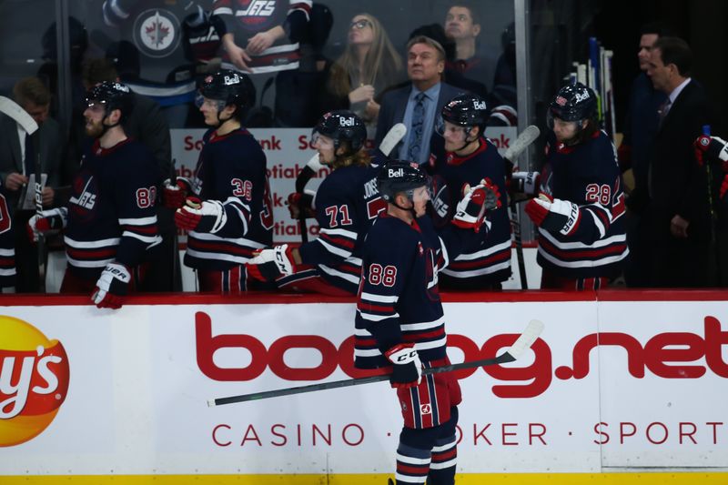 Jan 26, 2023; Winnipeg, Manitoba, CAN;  Winnipeg Jets defenseman Nate Schmidt (88) is congratulated by his team mates on his goal against the Buffalo Sabres during the third period at Canada Life Centre. Mandatory Credit: Terrence Lee-USA TODAY Sports