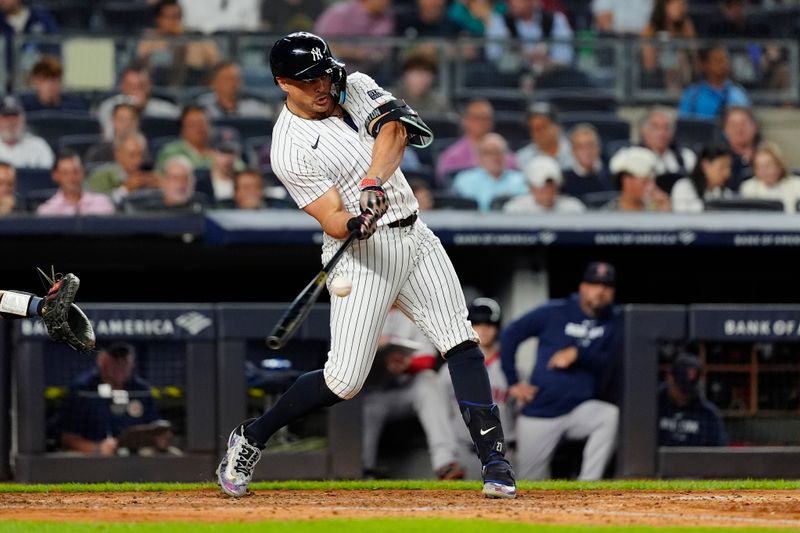 Sep 12, 2024; Bronx, New York, USA;  New York Yankees designated hitter Giancarlo Stanton (27) hits a single against the Boston Red Sox during the fourth inning at Yankee Stadium. Mandatory Credit: Gregory Fisher-Imagn Images