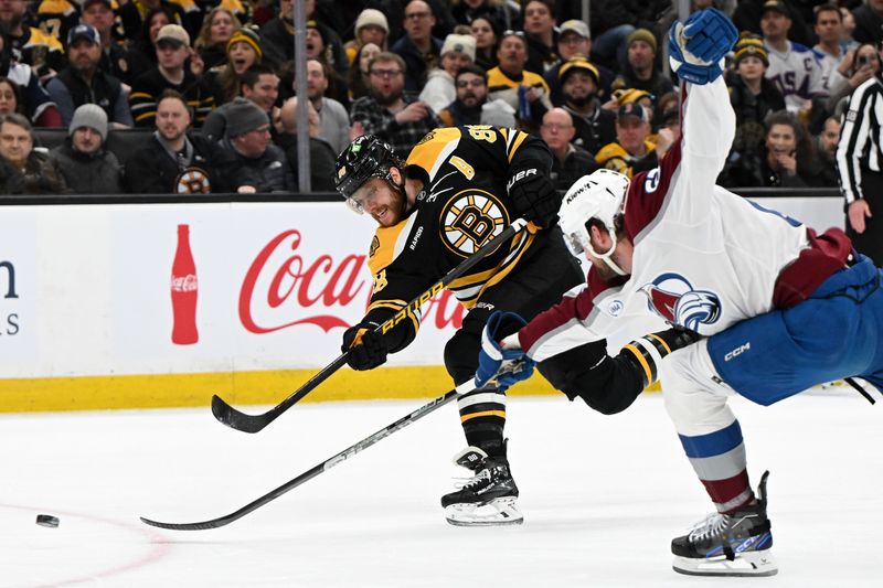 Jan 25, 2025; Boston, Massachusetts, USA; Boston Bruins right wing David Pastrnak (88) takes a shot against Colorado Avalanche defenseman Keaton Middleton (67) during the first period at the TD Garden. Mandatory Credit: Brian Fluharty-Imagn Images