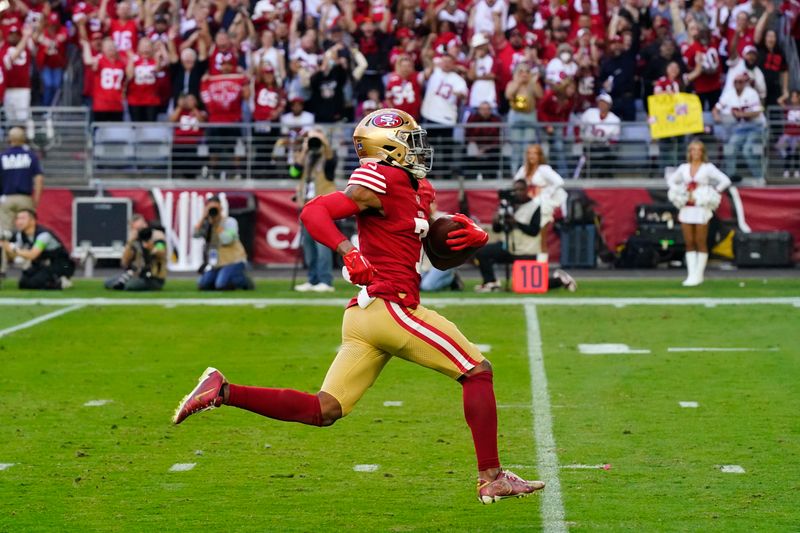 San Francisco 49ers cornerback Charvarius Ward returns an interception for a touchdown during the first half of an NFL football game against the Arizona Cardinals Sunday, Dec. 17, 2023, in Glendale, Ariz. (AP Photo/Ross D. Franklin)