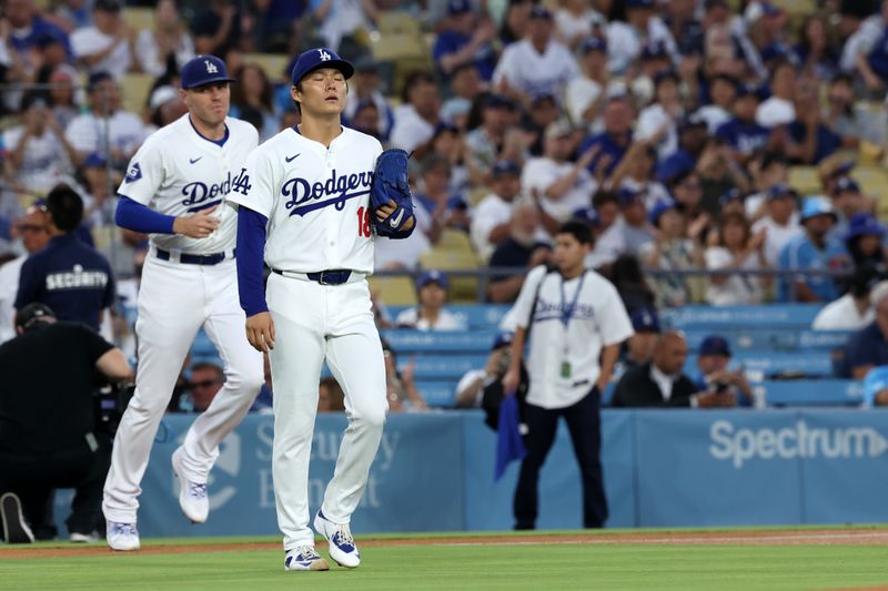 Sep 10, 2024; Los Angeles, California, USA;  Los Angeles Dodgers starting pitcher Yoshinobu Yamamoto (18) walks from a dugout to the mound at the beginning of the first inning against the Chicago Cubs at Dodger Stadium. Mandatory Credit: Kiyoshi Mio-Imagn Images