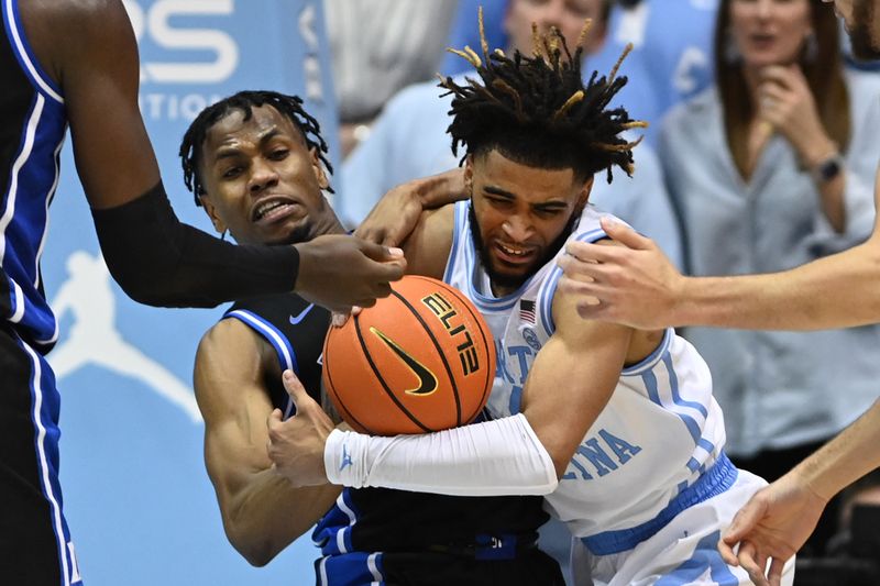 Mar 4, 2023; Chapel Hill, North Carolina, USA; Duke Blue Devils guard Jeremy Roach (3) and North Carolina Tar Heels guard R.J. Davis (4) fight for the ball in the second half at Dean E. Smith Center. Mandatory Credit: Bob Donnan-USA TODAY Sports