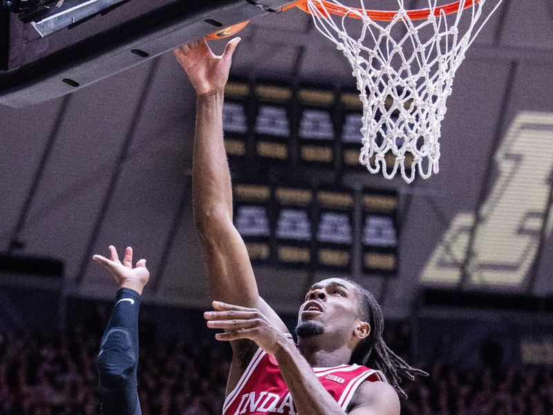 Feb 10, 2024; West Lafayette, Indiana, USA; Indiana Hoosiers forward Mackenzie Mgbako (21) shoots the ball while Purdue Boilermakers guard Lance Jones (55) defends in the first half at Mackey Arena. Mandatory Credit: Trevor Ruszkowski-USA TODAY Sports