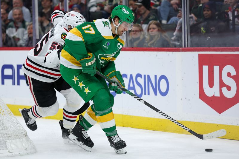 Jan 27, 2026; Saint Paul, Minnesota, USA; Minnesota Wild left wing Marcus Foligno (17) skates with the puck as Chicago Blackhawks defenseman Artyom Levshunov (55) defends during the second period at Grand Casino Arena. Mandatory Credit: Matt Krohn-Imagn Images