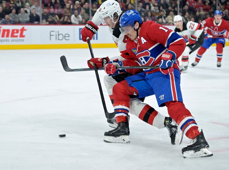 Jan 25, 2025; Montreal, Quebec, CAN; Montreal Canadiens forward Brendan Gallagher (11) and New Jersey Devils defenseman Luke Hughes (43) battle for the puck during the second period at the Bell Centre. Mandatory Credit: Eric Bolte-Imagn Images