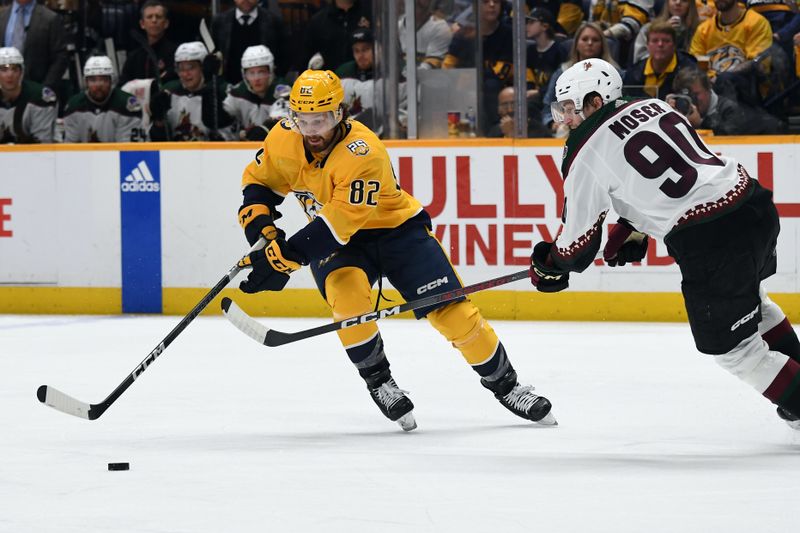 Feb 10, 2024; Nashville, Tennessee, USA; Nashville Predators center Tommy Novak (82) handles the puck against Arizona Coyotes defenseman J.J. Moser (90) during the first period at Bridgestone Arena. Mandatory Credit: Christopher Hanewinckel-USA TODAY Sports