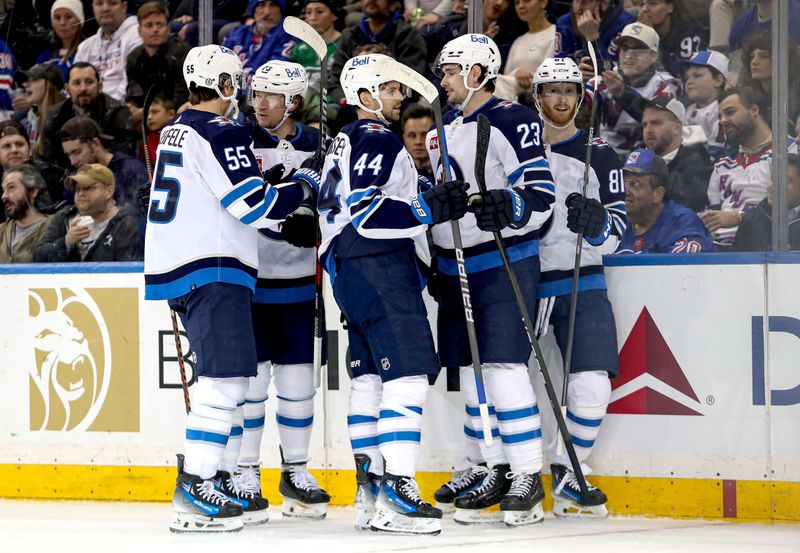 Mar 19, 2024; New York, New York, USA; Winnipeg Jets left wing Kyle Connor (81) celebrates his goal with center Sean Monahan (23), defenseman Josh Morrissey (44) and center Mark Scheifele (55) during the second period against the New York Rangers at Madison Square Garden. Mandatory Credit: Danny Wild-USA TODAY Sports