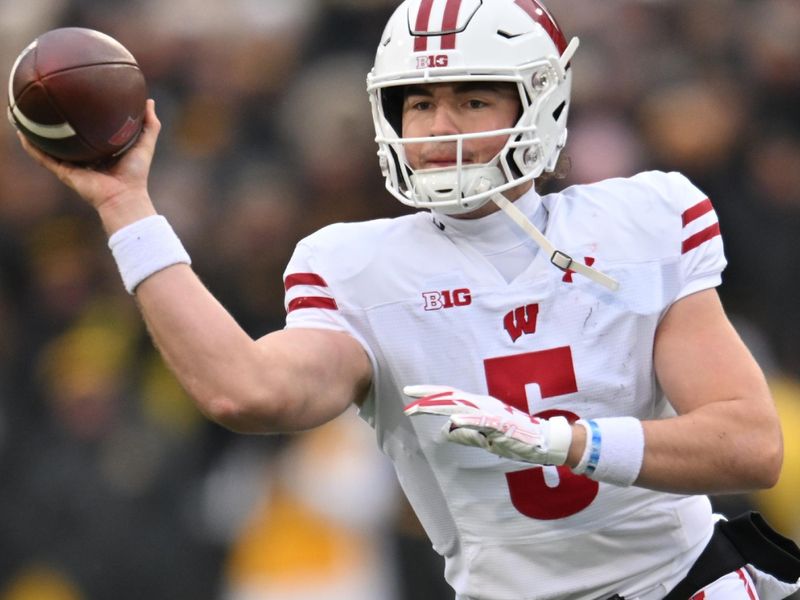  Nov 12, 2022; Iowa City, Iowa, USA; Wisconsin Badgers quarterback Graham Mertz (5) throws a pass against the Iowa Hawkeyes during the second quarter at Kinnick Stadium. Mandatory Credit: Jeffrey Becker-USA TODAY Sports