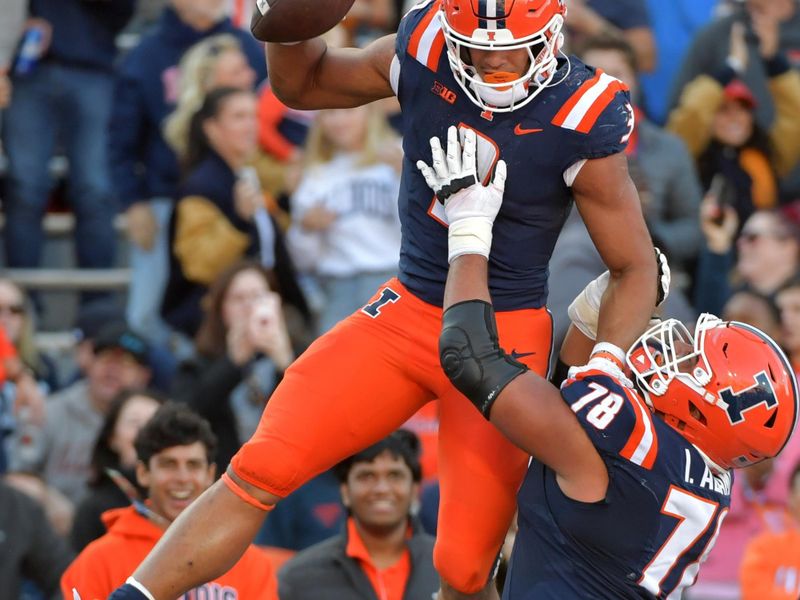 Oct 21, 2023; Champaign, Illinois, USA;  Illinois Fighting Illini running back Kaden Feagin (3) is lifted up by teammate Isaiah Adams (78) during the second half at Memorial Stadium. Mandatory Credit: Ron Johnson-USA TODAY Sports