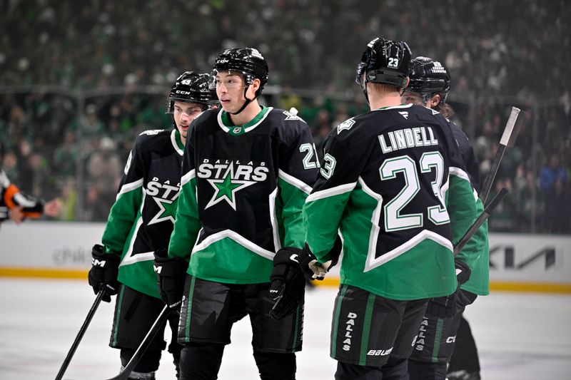 Nov 30, 2025; Dallas, Texas, USA; Dallas Stars center Justin Hryckowian (49) and left wing Jason Robertson (21) and defenseman Esa Lindell (23) celebrates a goal scored by Robertson against the Ottawa Senators during the second period at the American Airlines Center. Mandatory Credit: Jerome Miron-Imagn Images