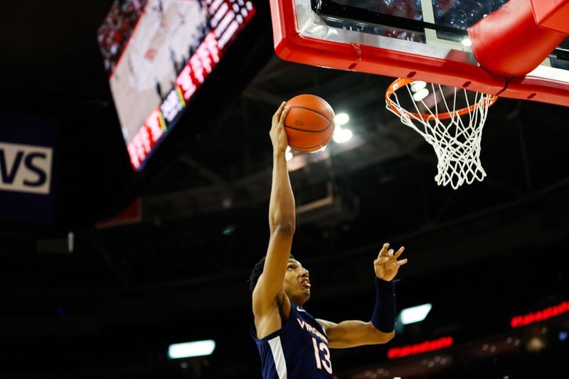 Jan 6, 2024; Raleigh, North Carolina, USA; Virginia Cavaliers guard Ryan Dunn (13) dunks the ball during the second half against North Carolina State Wolfpack at PNC Arena. Mandatory Credit: Jaylynn Nash-USA TODAY Sports