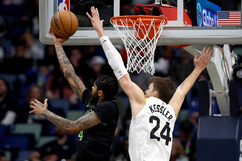 NEW ORLEANS, LOUISIANA - JANUARY 23: Brandon Ingram #14 of the New Orleans Pelicans makes a layup over Lauri Markkanen #23 of the Utah Jazz during the second quarter of an NBA game against the Utah Jazz at Smoothie King Center on January 23, 2024 in New Orleans, Louisiana. NOTE TO USER: User expressly acknowledges and agrees that, by downloading and or using this photograph, User is consenting to the terms and conditions of the Getty Images License Agreement. (Photo by Sean Gardner/Getty Images)