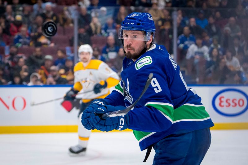 Jan 3, 2025; Vancouver, British Columbia, CAN; Vancouver Canucks forward J.T. Miller (9) reaches for the flying puck against the Nashville Predators in the second period at Rogers Arena. Mandatory Credit: Bob Frid-Imagn Images