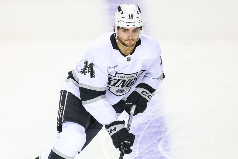 Nov 11, 2024; Calgary, Alberta, CAN; Los Angeles Kings right wing Alex Laferriere (14) skates during the warmup period against the Calgary Flames at Scotiabank Saddledome. Mandatory Credit: Sergei Belski-Imagn Images