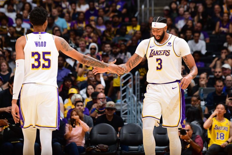 LOS ANGELES, CA - OCTOBER 15: Christian Wood #35 and Anthony Davis #3 of the Los Angeles Lakers high five during the game against the Milwaukee Bucks on October 15, 2023 at Crypto.Com Arena in Los Angeles, California. NOTE TO USER: User expressly acknowledges and agrees that, by downloading and/or using this Photograph, user is consenting to the terms and conditions of the Getty Images License Agreement. Mandatory Copyright Notice: Copyright 2023 NBAE (Photo by Adam Pantozzi/NBAE via Getty Images)