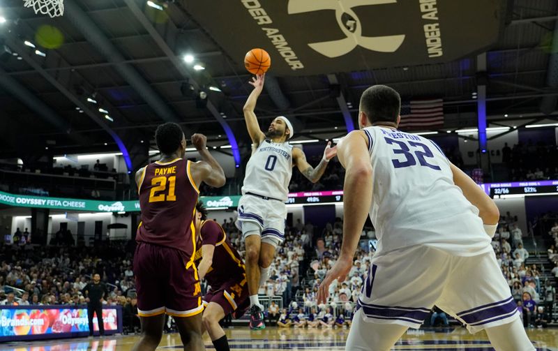 Mar 9, 2024; Evanston, Illinois, USA; Northwestern Wildcats guard Boo Buie (0) scores on Minnesota Golden Gophers forward Pharrel Payne (21) during the second half at Welsh-Ryan Arena. Mandatory Credit: David Banks-USA TODAY Sports