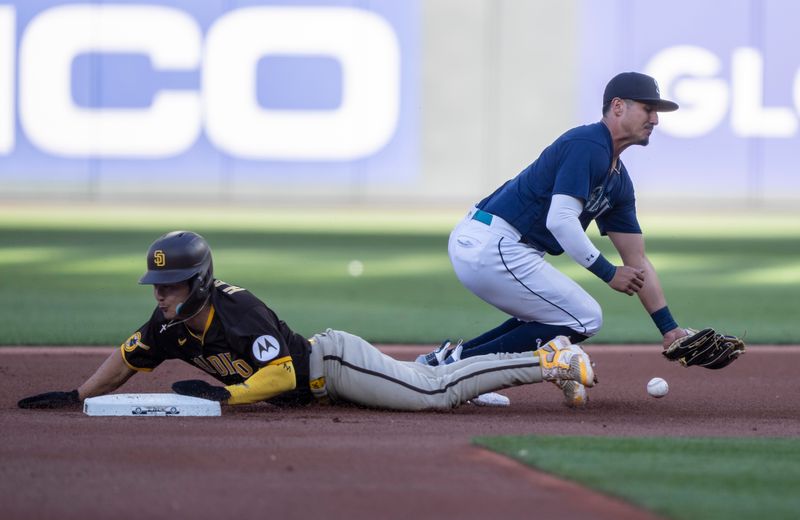 Aug 9, 2023; Seattle, Washington, USA; San Diego Padres second baseman Ha-Seong Kim (7) steals second base as Seattle Mariners second baseman Josh Rojas (4) cannot hold on to the ball during the first inning at T-Mobile Park. Mandatory Credit: Stephen Brashear-USA TODAY Sports