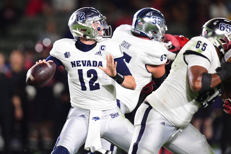 Nov 13, 2021; Carson, California, USA; Nevada Wolf Pack quarterback Carson Strong (12) throws as offensive lineman Aaron Frost (65) and offensive lineman Tyler Orsini (55) provide coverage against the San Diego State Aztecs defense during the first half at Dignity Health Sports Park. Mandatory Credit: Gary A. Vasquez-USA TODAY Sports