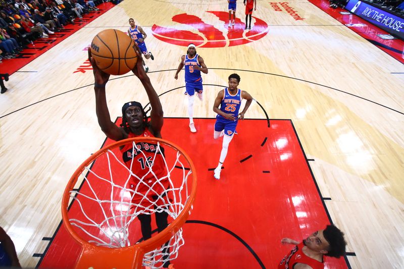 TORONTO, CANADA - MARCH 27: Mouhamadou Gueye #16 of the Toronto Raptors dunks the ball during the game against the New York Knicks on March 27, 2024 at the Scotiabank Arena in Toronto, Ontario, Canada.  NOTE TO USER: User expressly acknowledges and agrees that, by downloading and or using this Photograph, user is consenting to the terms and conditions of the Getty Images License Agreement.  Mandatory Copyright Notice: Copyright 2024 NBAE (Photo by Vaughn Ridley/NBAE via Getty Images)