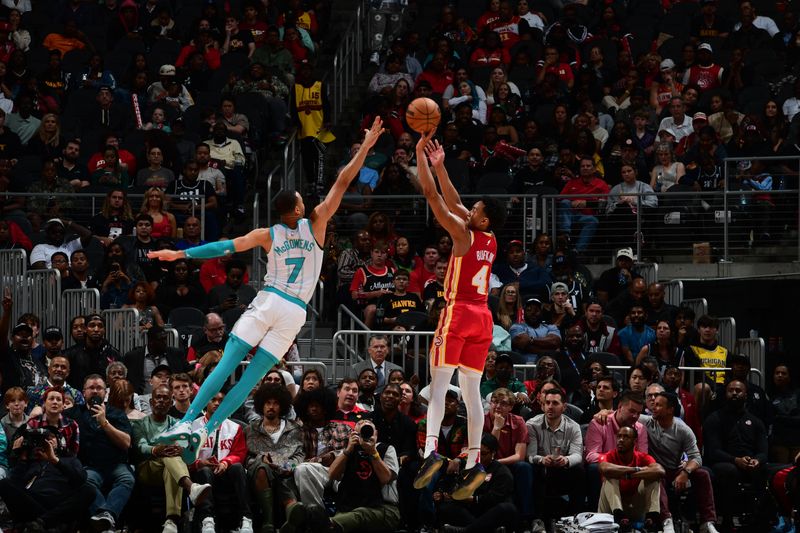 ATLANTA, GA - APRIL 10: Kobe Bufkin #4 of the Atlanta Hawks shoots the ball defended by Bryce McGowans #7 of the Charlotte Hornets during the game on April 10, 2024 at State Farm Arena in Atlanta, Georgia.  NOTE TO USER: User expressly acknowledges and agrees that, by downloading and/or using this Photograph, user is consenting to the terms and conditions of the Getty Images License Agreement. Mandatory Copyright Notice: Copyright 2024 NBAE (Photo by Scott Cunningham/NBAE via Getty Images)