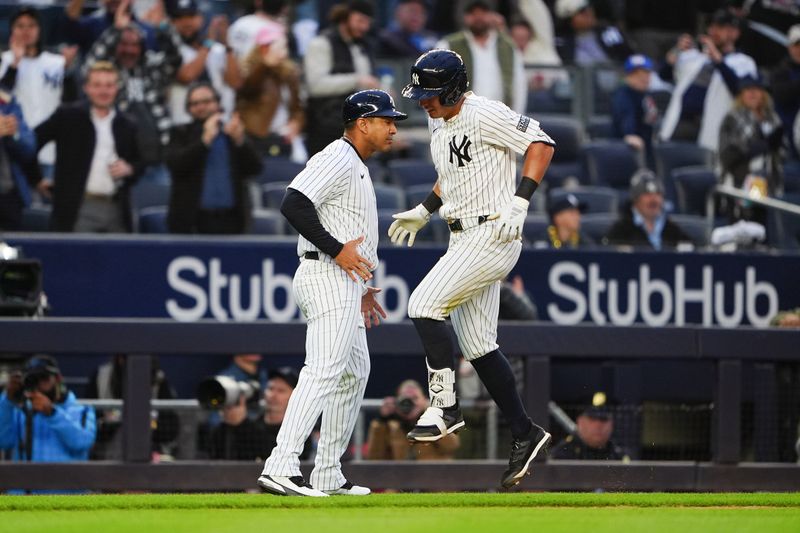 Apr 8, 2024; Bronx, New York, USA; New York Yankees third base coach Luis Rojas (67) celebrates with shortstop Anthony Volpe (11) after hitting a three run home run against the Miami Marlins during the fourth inning at Yankee Stadium. Mandatory Credit: Gregory Fisher-USA TODAY Sports