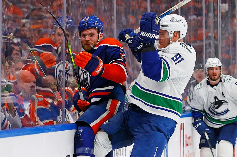 May 12, 2024; Edmonton, Alberta, CAN; Vancouver Canucks defensemen Nikita Zadorov (91) checks Edmonton Oilers forward Leon Draisaitl (29) during the third period in game three of the second round of the 2024 Stanley Cup Playoffs at Rogers Place. Mandatory Credit: Perry Nelson-USA TODAY Sports