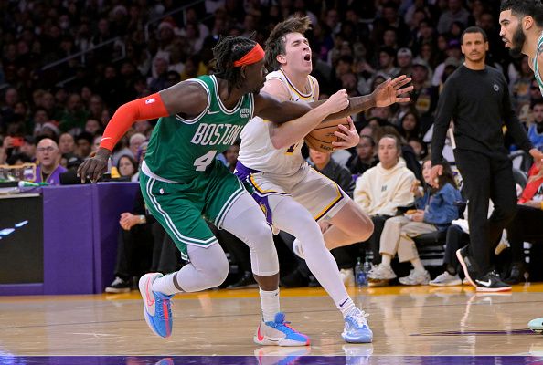 LOS ANGELES, CALIFORNIA - DECEMBER 25: Jrue Holiday #4 of the Boston Celtics defends Austin Reaves #15 of the Los Angeles Lakers in the first half at Crypto.com Arena on December 25, 2023 in Los Angeles, California. NOTE TO USER: User expressly acknowledges and agrees that, by downloading and or using this photograph, User is consenting to the terms and conditions of the Getty Images License Agreement.(Photo by Jayne Kamin-Oncea/Getty Images)