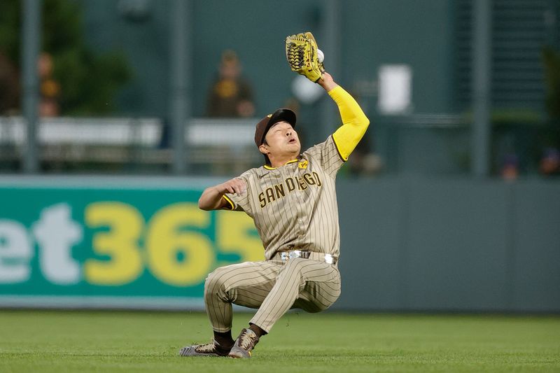 Apr 22, 2024; Denver, Colorado, USA; San Diego Padres shortstop Ha-Seong Kim (7) makes a catch as he falls down in the fifth inning against the Colorado Rockies at Coors Field. Mandatory Credit: Isaiah J. Downing-USA TODAY Sports