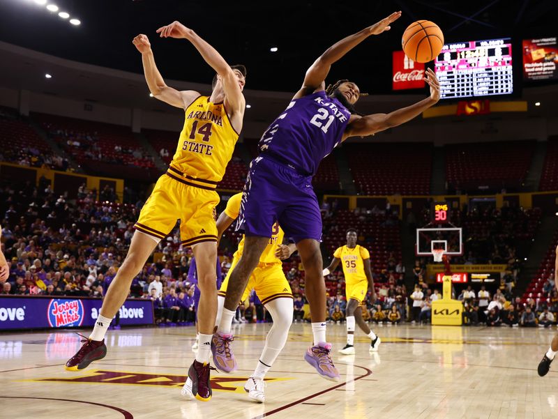 Jan 10, 2026; Tempe, Arizona, USA; Kansas State Wildcats forward Khamari McGriff (21) grabs a rebound against Arizona State Sun Devils forward Andrija Grbovic (14) in the first half at Desert Financial Arena. Mandatory Credit: Mark J. Rebilas-Imagn Images