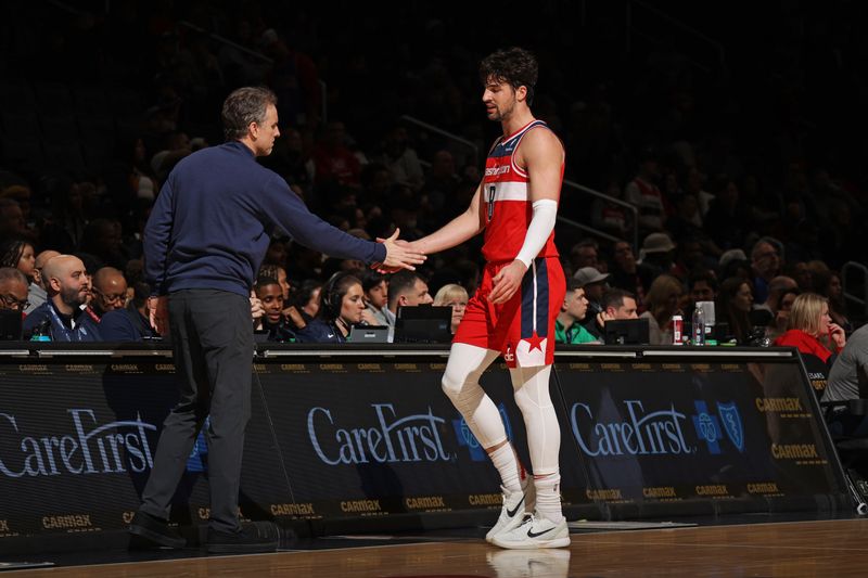 WASHINGTON, DC -? MARCH 27:  Deni Avdija #8 and Interim Head Coach Brian Keefe of the Washington Wizards high five during the game against the Brooklyn Nets on March 27, 2024 at Capital One Arena in Washington, DC. NOTE TO USER: User expressly acknowledges and agrees that, by downloading and or using this Photograph, user is consenting to the terms and conditions of the Getty Images License Agreement. Mandatory Copyright Notice: Copyright 2024 NBAE (Photo by Stephen Gosling/NBAE via Getty Images)