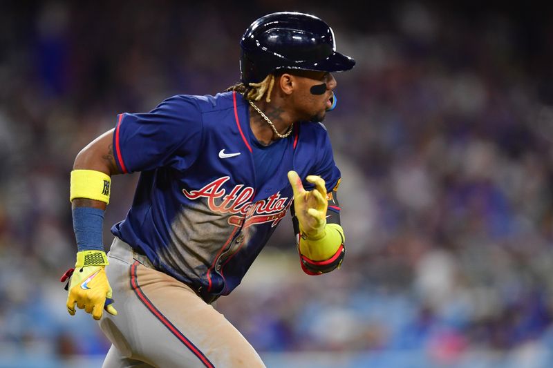 May 4, 2024; Los Angeles, California, USA; Atlanta Braves right fielder Ronald Acuna Jr. (13) runs after hitting a single against the Los Angeles Dodgers during the eighth inning at Dodger Stadium. Mandatory Credit: Gary A. Vasquez-USA TODAY Sports