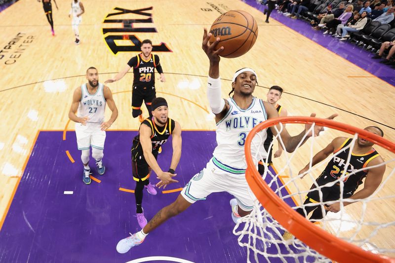 PHOENIX, ARIZONA - NOVEMBER 15: Jaden McDaniels #3 of the Minnesota Timberwolves attempts a shot against the Phoenix Suns during the second half of the NBA game at Footprint Center on November 15, 2023 in Phoenix, Arizona. The Suns defeated the Timberwolves 133-115. NOTE TO USER: User expressly acknowledges and agrees that, by downloading and or using this photograph, User is consenting to the terms and conditions of the Getty Images License Agreement.  (Photo by Christian Petersen/Getty Images)