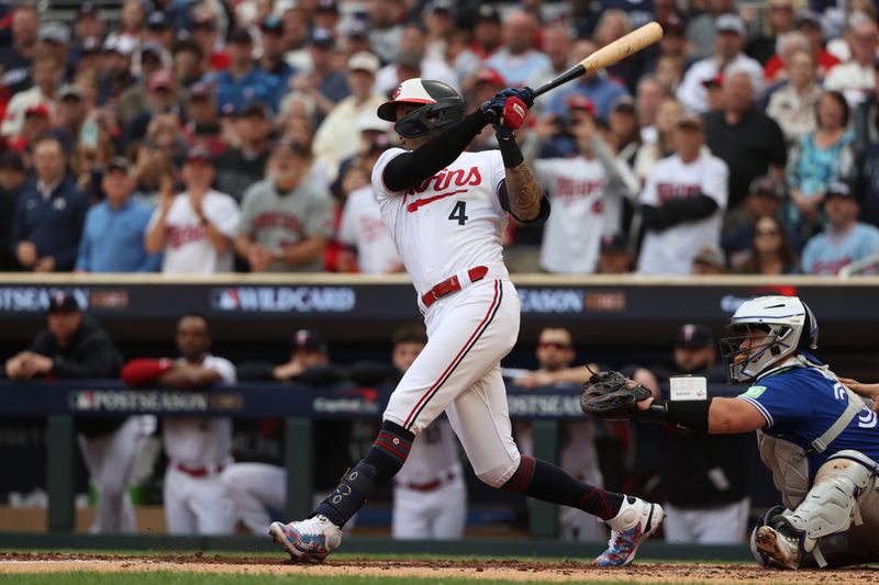 Oct 4, 2023; Minneapolis, Minnesota, USA; Minnesota Twins shortstop Carlos Correa (4) hits an RBI-single in the fourth inning against the Toronto Blue Jays during game two of the Wildcard series for the 2023 MLB playoffs at Target Field. Mandatory Credit: Jesse Johnson-USA TODAY Sports