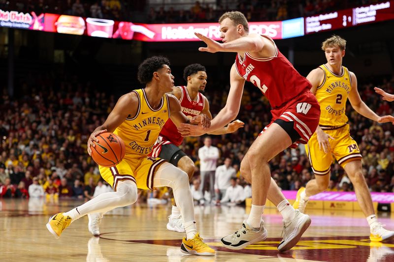 Jan 13, 2026; Minneapolis, Minnesota, USA; Minnesota Golden Gophers guard Isaac Asuma (1) dribbles the ball as Wisconsin Badgers forward Aleksas Bieliauskas (32) defends during the first half at Williams Arena. Mandatory Credit: Matt Krohn-Imagn Images
