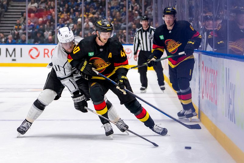 Mar 25, 2024; Vancouver, British Columbia, CAN; Los Angeles Kings forward Anze Kopitar (11) checks Vancouver Canucks forward Elias Pettersson (40) in the third period at Rogers Arena. Kings won 3 -2. Mandatory Credit: Bob Frid-USA TODAY Sports