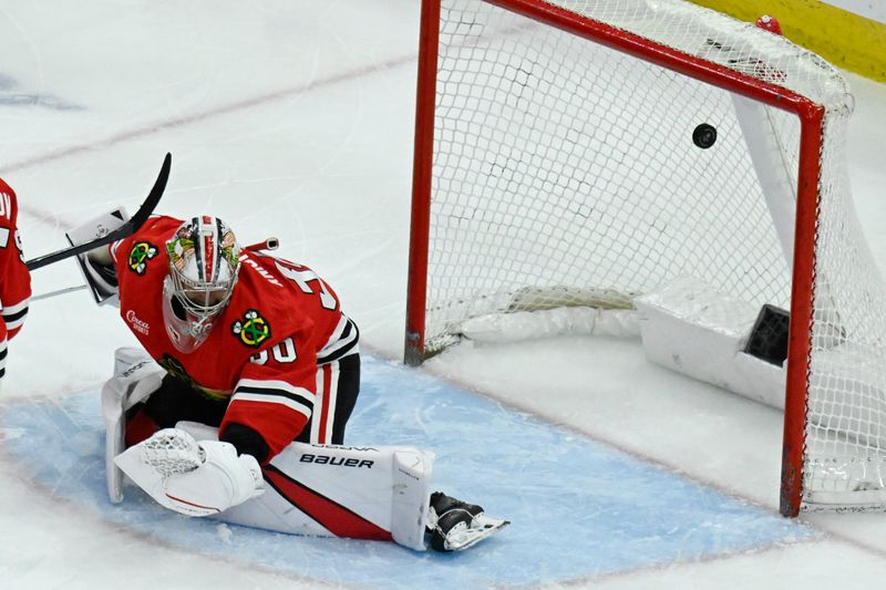 Apr 12, 2025; Chicago, Illinois, USA;  Chicago Blackhawks goaltender Spencer Knight (30) misses a shot on goal by Winnipeg Jets defenseman Josh Morrissey (44) during the third period at United Center. Mandatory Credit: Matt Marton-Imagn Images