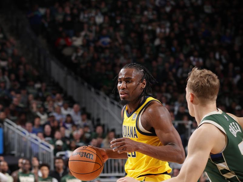 MILWAUKEE, WI - APRIL  25: Aaron Nesmith #23 of the Indiana Pacers drives to the basket during the game against the Milwaukee Bucks during Round 1 Game 3 of the 2025 NBA Playoffs on April 25, 2025 at Fiserv Forum Center in Milwaukee, Wisconsin. NOTE TO USER: User expressly acknowledges and agrees that, by downloading and or using this Photograph, user is consenting to the terms and conditions of the Getty Images License Agreement. Mandatory Copyright Notice: Copyright 2025 NBAE (Photo by Gary Dineen/NBAE via Getty Images).