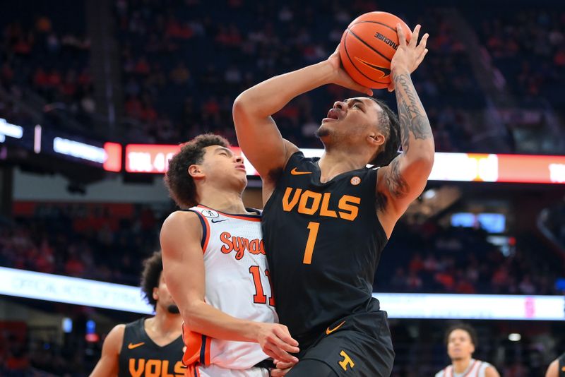 Dec 2, 2025; Syracuse, New York, USA; Tennessee Volunteers guard Amari Evans (1) drives against Syracuse Orange guard Naithan George (11) during the first half at the JMA Wireless Dome. Mandatory Credit: Rich Barnes-Imagn Images