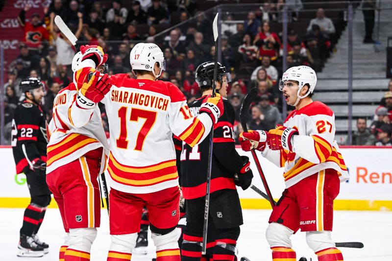 Nov 25, 2024; Ottawa, Ontario, CAN; Calgary Flames center Yegor Sharangovich (17) celebrates his goal against the Ottawa Senators with his teammates during the second period at Canadian Tire Centre. Mandatory Credit: David Kirouac-Imagn Images